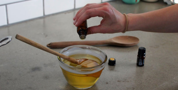 Pouring essential oils into the wax/oil mixture